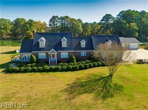 cape cod house with a front yard