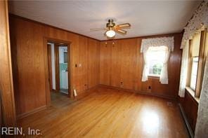 364 Millers Ln, Susan, VA 23163 - empty room featuring light wood-style floors, wooden walls, and a ceiling fan