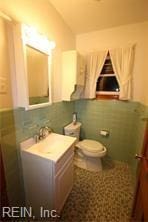 364 Millers Ln, Susan, VA 23163 - half bathroom featuring vaulted ceiling, speckled floor, vanity, and toilet