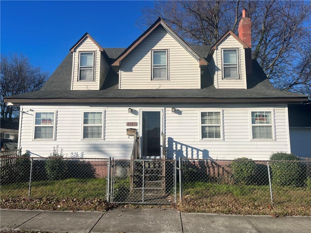 2129 Vincent Ave, Norfolk, VA 23504 - cape cod home with a fenced front yard, a chimney, and a gate