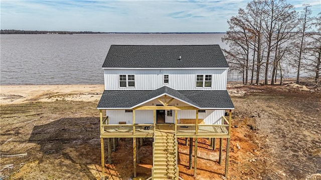 view of front of property with a deck with water view