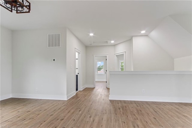 interior space featuring vaulted ceiling and light hardwood / wood-style flooring