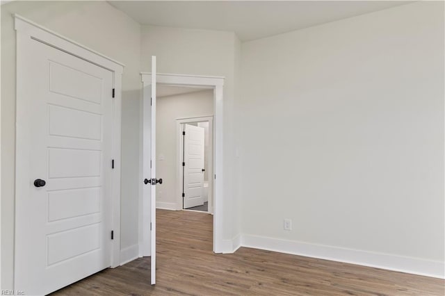 empty room with dark hardwood / wood-style floors