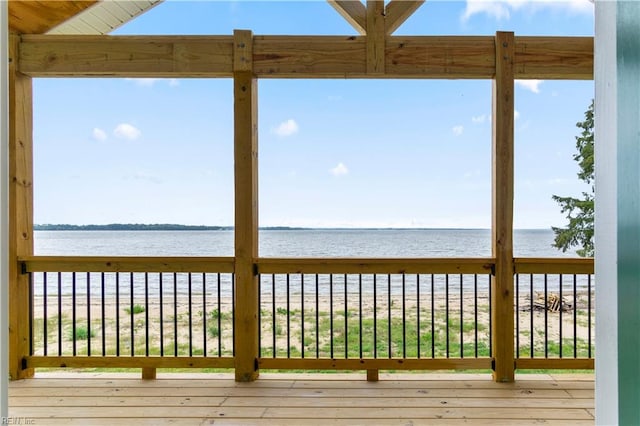 wooden terrace featuring a water view