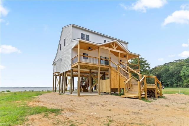 exterior space with a water view and ceiling fan