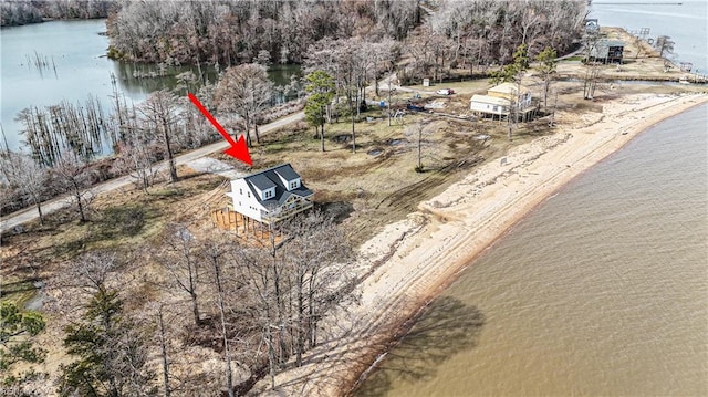 drone / aerial view featuring a beach view and a water view