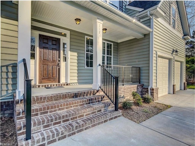 property entrance with covered porch and a garage