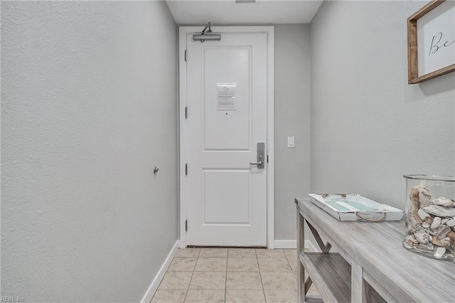 doorway with light tile floors