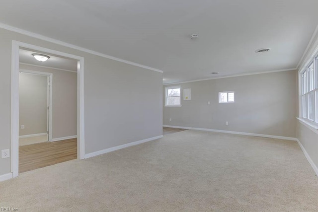 empty room featuring a healthy amount of sunlight and ornamental molding