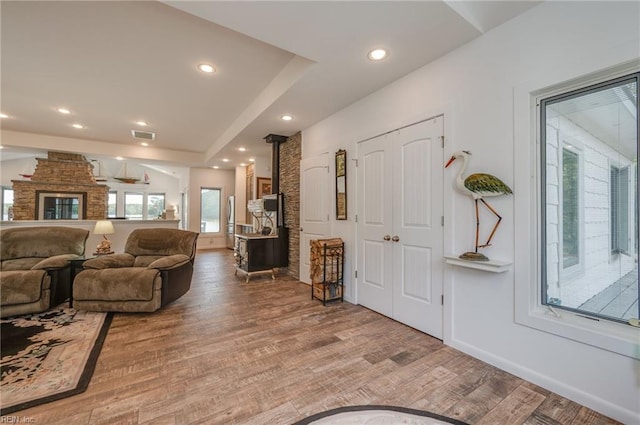 living room featuring a raised ceiling and wood-type flooring