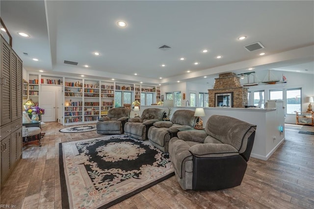 living room featuring dark hardwood / wood-style flooring and a fireplace