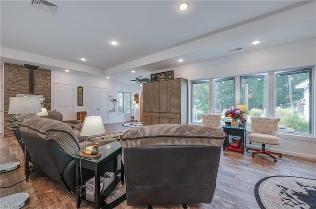 living room featuring a wood stove and dark hardwood / wood-style floors