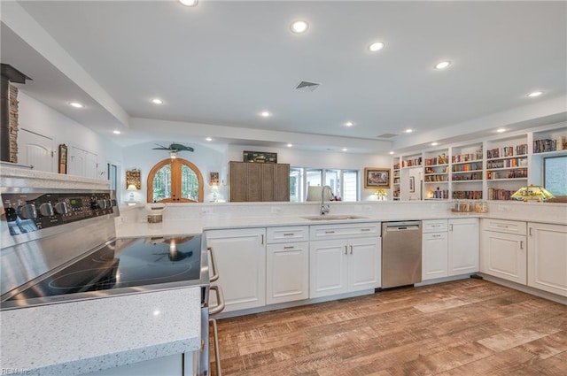 kitchen featuring white cabinets, light hardwood / wood-style flooring, dishwasher, and sink