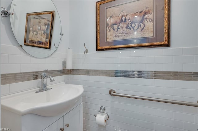 bathroom featuring backsplash, tile walls, and vanity with extensive cabinet space