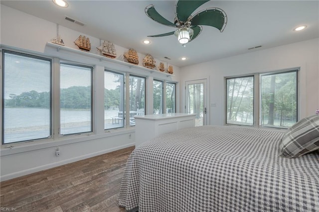 bedroom with ceiling fan and dark wood-type flooring