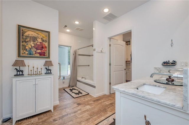 bathroom with hardwood / wood-style flooring, curtained shower, and vanity