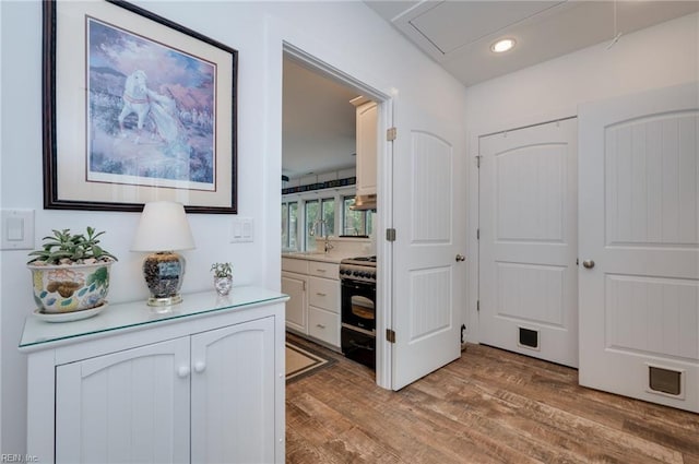 hallway with light hardwood / wood-style flooring