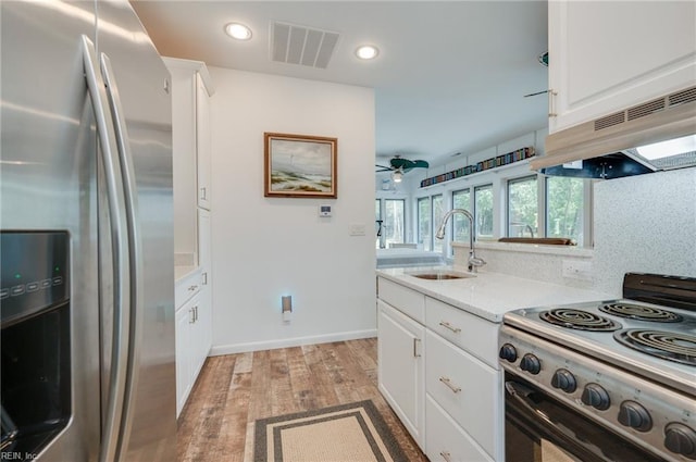 kitchen featuring light hardwood / wood-style floors, electric range, ceiling fan, stainless steel fridge with ice dispenser, and white cabinetry