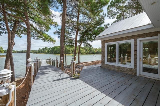 exterior space featuring a dock and a water view