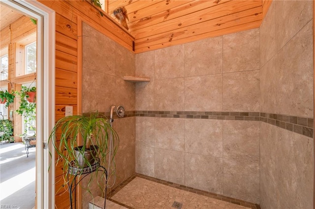 bathroom with wood ceiling, vaulted ceiling, and tiled shower