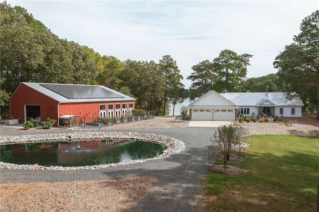 exterior space with central AC, a garage, and an outdoor structure