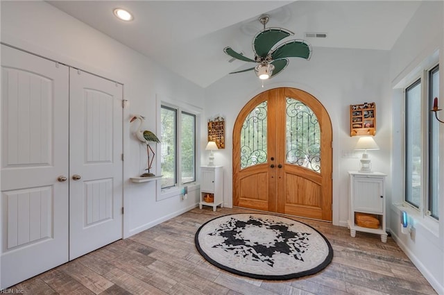 foyer featuring light hardwood / wood-style flooring, ceiling fan, and lofted ceiling