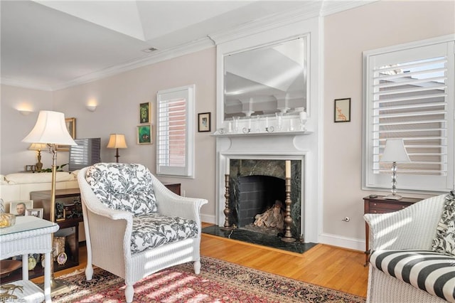 living room featuring a premium fireplace, hardwood / wood-style floors, and ornamental molding