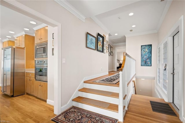 stairway with light wood-type flooring and ornamental molding