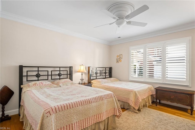 bedroom featuring ornamental molding, ceiling fan, and light hardwood / wood-style flooring