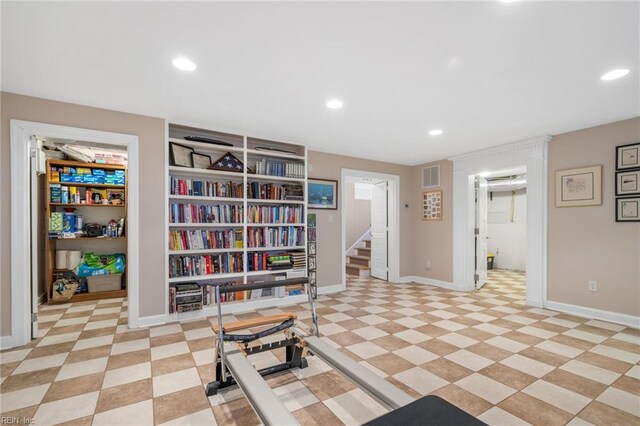 exercise area featuring light tile floors