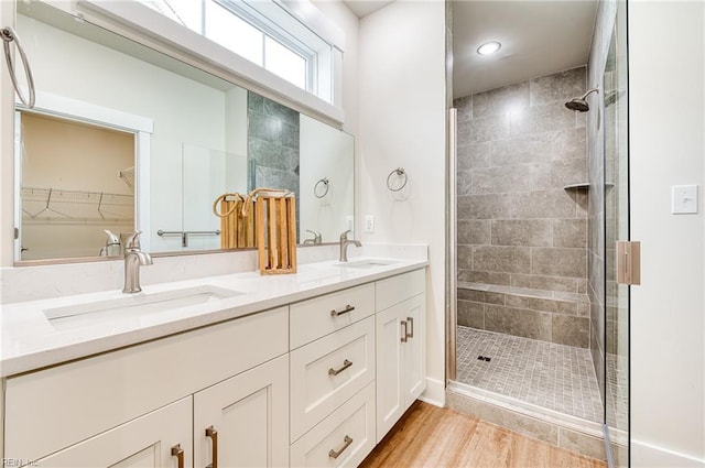 bathroom with a shower with door, vanity, and hardwood / wood-style floors