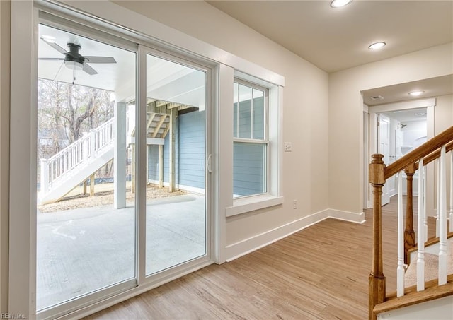 doorway to outside featuring wood-type flooring and ceiling fan