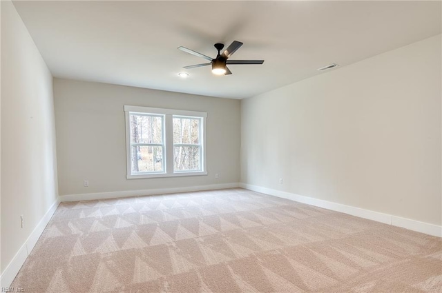 carpeted spare room with ceiling fan