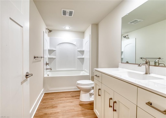 full bathroom featuring hardwood / wood-style flooring, shower / tub combination, vanity, and toilet