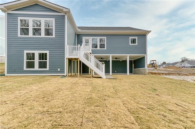 rear view of property with a lawn