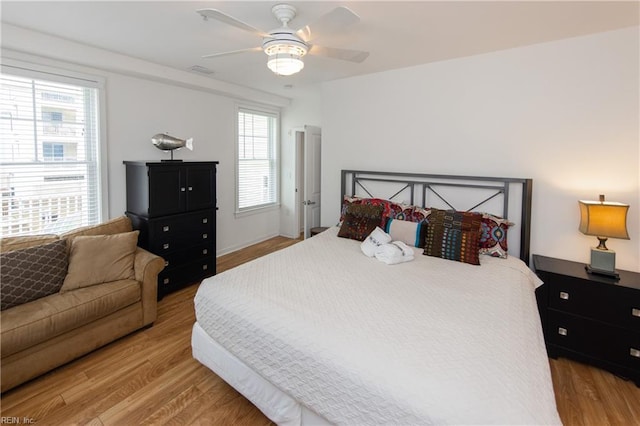 bedroom with light hardwood / wood-style flooring and ceiling fan