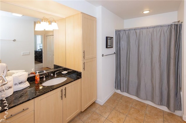 bathroom with an inviting chandelier, tile flooring, and oversized vanity