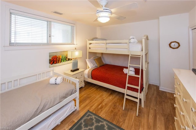 bedroom with ceiling fan and wood-type flooring