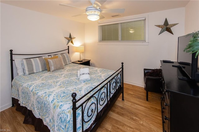 bedroom with ceiling fan and light hardwood / wood-style flooring