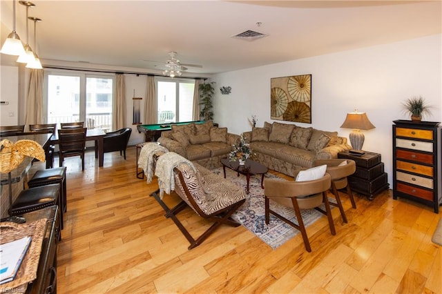 living room featuring ceiling fan, pool table, and light wood-type flooring