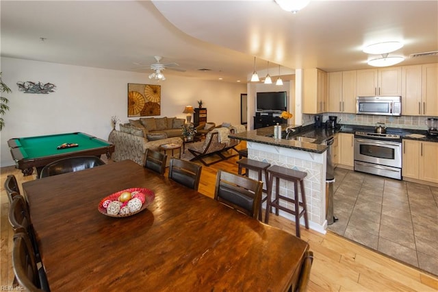 dining area with pool table, ceiling fan, sink, and light tile flooring