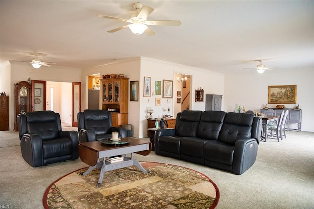 carpeted living room featuring ceiling fan and ornamental molding