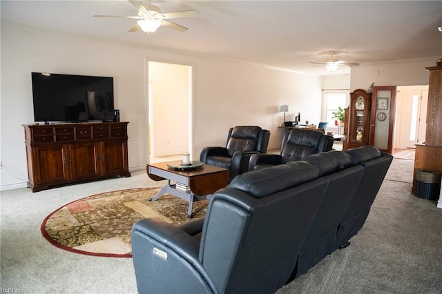 carpeted living room featuring ceiling fan and ornamental molding