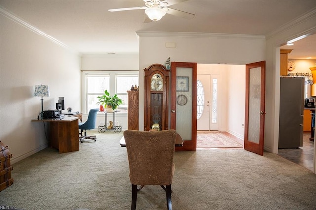 sitting room with dark colored carpet, ceiling fan, and ornamental molding