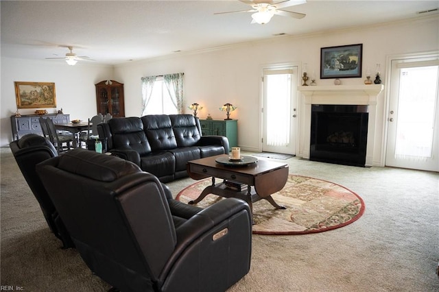 living room featuring light carpet, ceiling fan, and a wealth of natural light