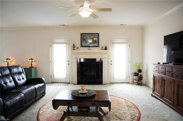 living room with light carpet, plenty of natural light, crown molding, and ceiling fan