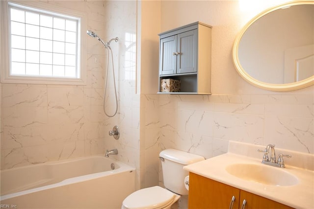 full bathroom with tile walls, toilet, vanity with extensive cabinet space, tiled shower / bath, and backsplash