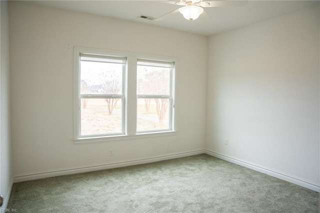 spare room with light colored carpet and ceiling fan