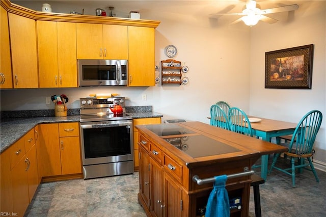 kitchen with light tile floors, appliances with stainless steel finishes, and ceiling fan