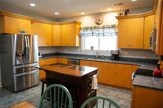 kitchen featuring light tile floors, sink, and stainless steel appliances